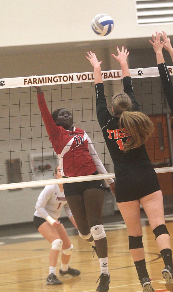Austin’s Awenia Nywesh tips the ball for the Packers in a Section 1AAA tournament match in Farmington Wednesday. Matt Steichen/Farmington Independent
