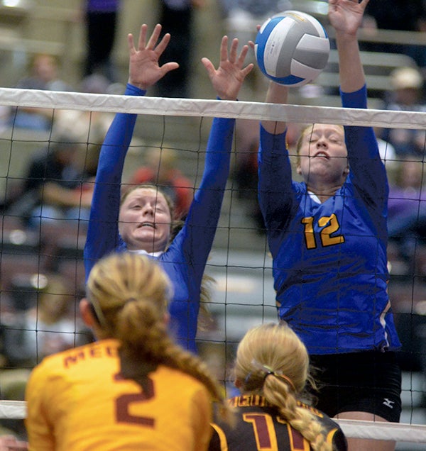Hayfield’s Emily Sprau, left, and Kate Kruger, right, defend the net against Medford in the Section 1A West semifinals in Mayo Civic Center in Rochester Saturday. Rocky Hulne/sports@austindailyherald.com