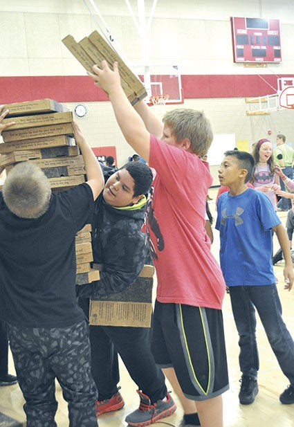  Fifth grader Joseph Ramos, center, gets by with a little help from his friends as they try to keep pizza boxes vertical.