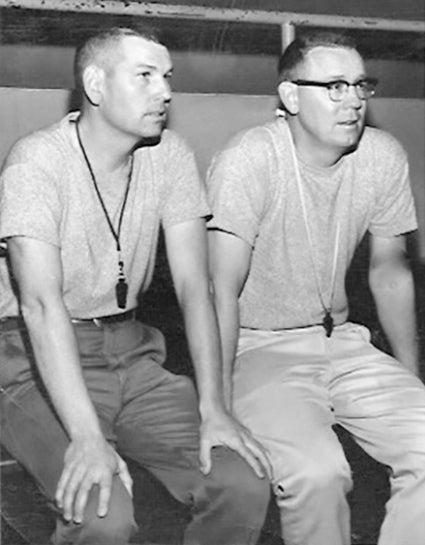 Former Austin High School basketball coach Oscar Haddorff, left, sits with Dick Seltz on the gym bleachers. Haddorff died Oct. 25. Photo provided