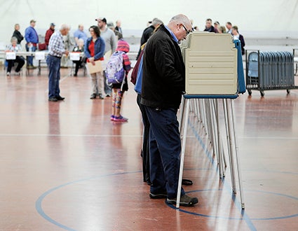 Mike Ankeny, a member of the Mower County Commission votes Tuesday morning at Austin High School. 