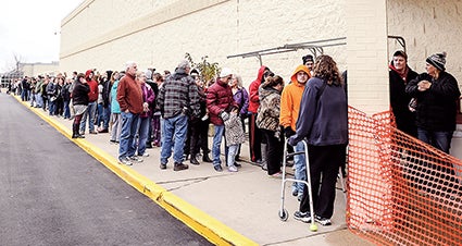 A line stretches out the length of the store at Shopko as shoppers wait to enter and take advantage of Black Friday deals. 