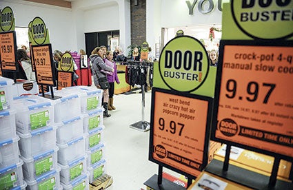 Shoppers look through a forest of door-buster deals on Thanksgiving in 2015 evening outside of Younkers. Herald file photo