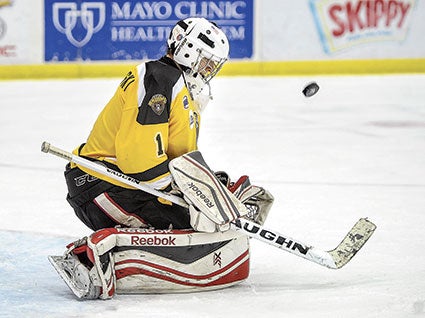  The Austin Bruins goalie Jake Kucharski makes a stop in the first inning against the Minnesota Magicians Saturday night at Riverside Arena. 