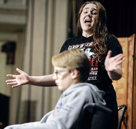 Grace Shupe, playing Rita La Porta sings a number during a scene with Ryan Stencel as the dead body during rehearsal for the upcoming Austin High School presentation of “Lucky Stiff.” Eric Johnson/photodesk@austindailyherald.com