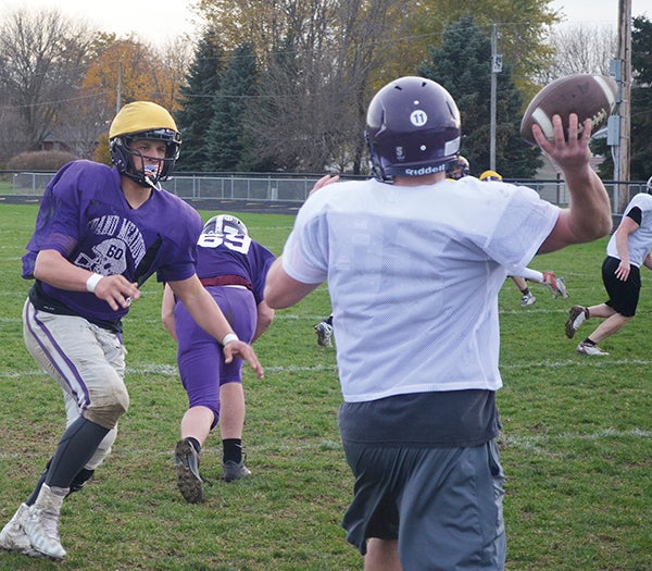 Grand Meadow’s Blake Benson, left, rushes the passer in practice in GM Wednesday. Rocky Hulne/sports@austindailyherald.com