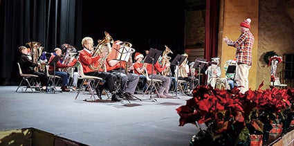 Austin High School band director Bradley Mariska directs the Merry TubaChristmas show Saturday at the Paramount Theatre. 