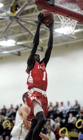 Austin’s Both Gach goes up for a two-handed dunk against Byron in the second half Tuesday night in Packer Gym. Eric Johnson/photodesk@austindailyherald.com