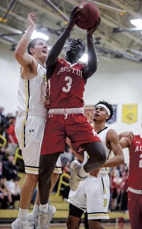 Austin’s Moses Issa goes up strong against Byron’s Bjorn Knutson during the first half Tuesday night in Packer Gym. Eric Johnson/photodesk@austindailyherald.com