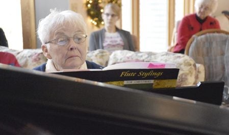 Janet Gilbertson at the grand piano, plays with flutist Amy Unseth. Deb Nicklay/deb.nicklay@austindailyherald.com