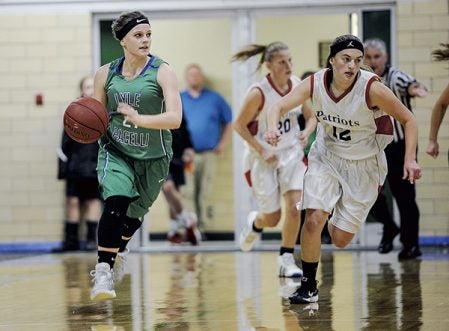 Lyle-Pacelli’s Abigail Bollingberg brings the ball up court looking for an outlet during the first half against Hope Lutheran at Pacelli. Eric Johnson/photodesk@austindailyherald.com