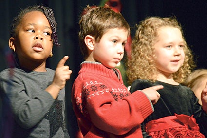 From left, Gabrielle Tebandeke, Tanner Zavoral and Emma Shaw, of the Afternoon KPrep class, offer up a favorite during a recent Christmas concert.