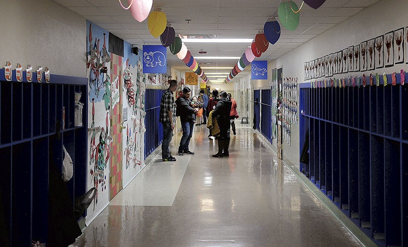 Parents begin cycling through the hallways of Woodson Kindergarten Center with their children, looking at the decorated doors Tuesday afternoon. Photos by Eric Johnson/photodesk@austindailyherald.com