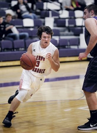 LeRoy-Ostrander’s Sean Lohuis takes the ball to the baseline during the first half against Goodhue Wednesday night in Grand Meadow. Eric Johnson/photodesk@austindailyherald.com