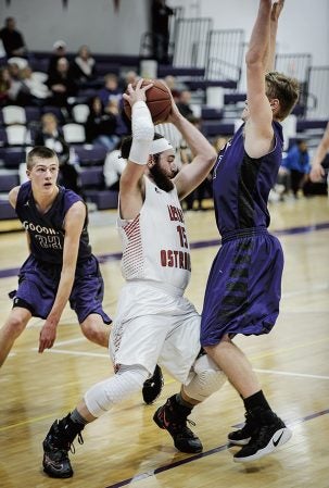 LeRoy-Ostrander’s Zach Hanson tries to work out of a jam in the first half against Goodhue Wednesday night in Grand Meadow. Eric Johnson/photodesk@austindailyherald.com