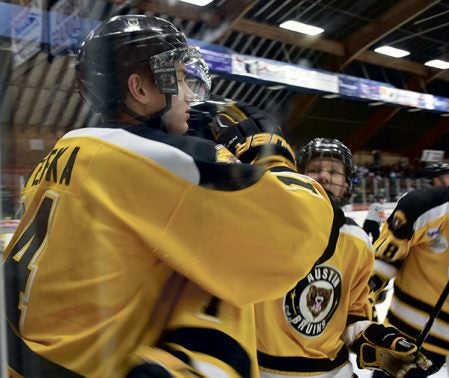 Jan Stefka is congratulated by his Bruins teammates after he scores his second goal of the game in the second period against Brookings in Riverside Arena Wednesday. Rocky Hulne/sports@austindailyherald.com