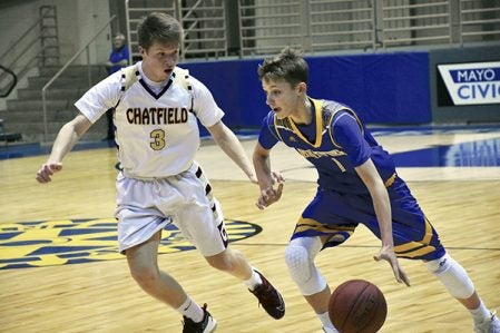 Hayfield’s Mason Tapp dribbles past Chatfield’s Dillon Bance in Mayo Civic Center Friday. Rocky Hulne/sports@austindailyherald.com