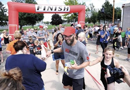 Kelly Nesvold greets supporters after completing the 300M4FREEDOM this summer at Cornerstone Church. Herald file photo
