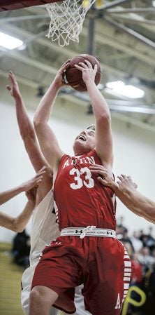 Austin’s Oberbroeckling rips down a rebound during the first half against Rochester Century Tuesday night in Packer Gym. Eric Johnson/photodesk@austindailyherald.com