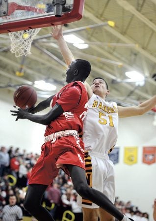 Austin’s Duoth Gach goes underneath in the first half Friday night in Packer Gym. Eric Johnson/photodesk@austindailyherald.com