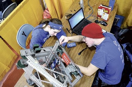 Thomas Shaw, right and Kayla Nelsen of the Southland Stompers work on their robot during the Austin Public Schools and Riverland College Southern Minnesota VEX Robotic Competition. Eric Johnson/photodesk@austindailyherald.com