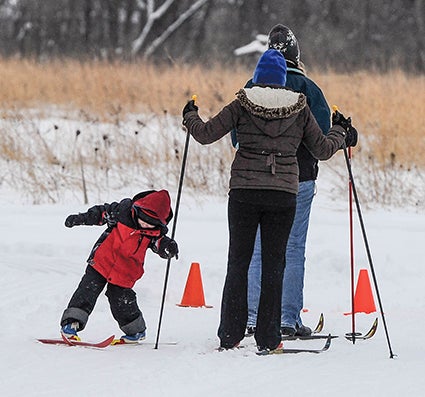 Five-year-old Teddy Schoenstedt holds on to his mom Heather’s pole as he tries to right himself just before the start of the kids/beginner’s race of the annual Dammen Nordic Cross Country Ski Race Saturday at the Jay C. Hormel Nature Center.