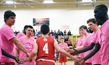 Tate Hebrink is announced during the starting lineups on the Paint the Gym Pink Night in Packer Gym Monday. 