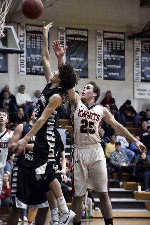 Blooming Prairie’s Cameron Kubista goes up for a lay up against Kenyon-Wanamingo’s Calvin Steberg in BP Friday. Rocky Hulne/sports@austindailyherald.com