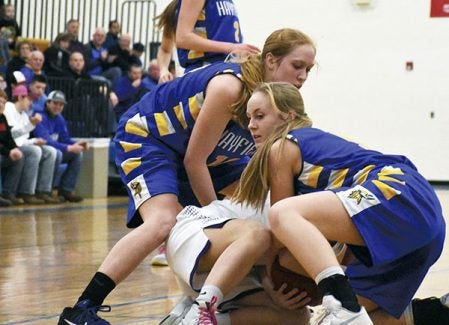 Hayfield’s Kate Kruger, left, and Carrie Rutledge, right, force a jump ball against Rochester Lourdes in Hayfield Saturday. Rocky Hulne/sports@austindailyherald.com
