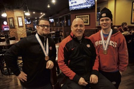Austin grad Bob Motzko recently coached the United States junior hockey team to a national title. Pictured are: Motzko, center, Matt Chapman, left, and Jack Ahcan, right. Chapman was the Team USA video coach, while Ahcan played defense for the USA. He is a resident of Savage and is a freshman at SCSU on the team. Photo Provided by SCSU Athletic Media Relations