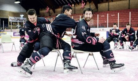 Charlie Spetz, from left, Toby Sengvongxay and Jack Murphy play musical chairs during the jersey auction Friday night at Riverside Arena. Eric Johnson/photodesk@austindailyherald.com