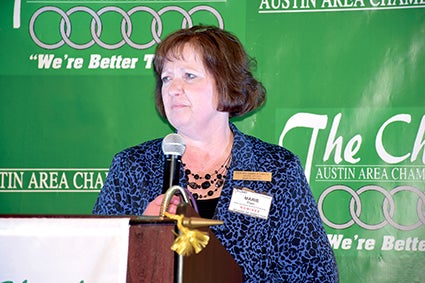 Belles & Beaus Bridal & Formal Wear owner Marie Fryer accepts the award for Small Business of the Year at Thursday’s Austin Area Chamber of Commerce annual banquet. 