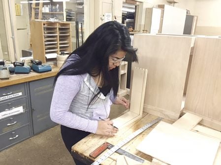 Reyna Andrade Avalos works on wood projects at Austin High School. Photo provided.