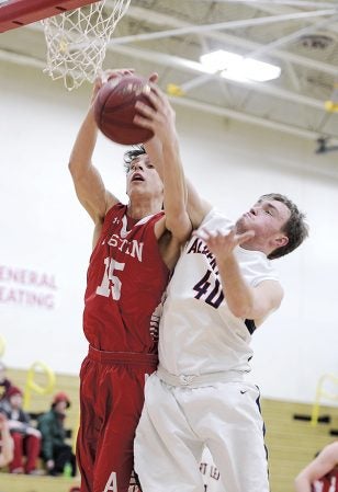 Austin’s Trent Brown contends for a rebound with Albert Lea’s Parker Anderson during the first half of their Section 1AAA Tournament matchup Wednesday night in Packer Gym. Eric Johnson/photodesk@austindailyherald.com