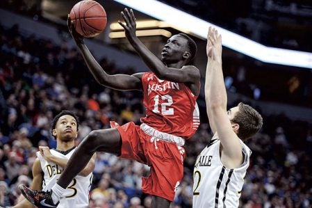 Austin’s Ngor Deng goes in for a late second-half lay-up against DeLaSalle in the Class AAA Minnesota State Boys Basketball Tournament championship Saturday night at Target Center. Eric Johnson/photodesk@austindailyherald.com