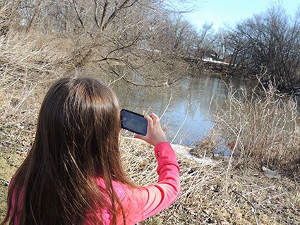 Aubrey Ruzek, 7, uses her dad’s smartphone Saturday to take pictures of wildlife along the Cedar River. Photos provided