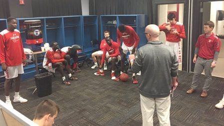 Austin head coach Kris Fadness talks to the Austin boys basketball team in the locker room before the team's semifinal matchup against Marshall Thursday at the Target Center in Minneapolis. Photo courtesy of @HoopsAhs on Twitter. 
